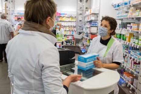 Infirmière libérale récupérant sa dotation hebdomadaire de masques chirurgicaux dans une pharmacie